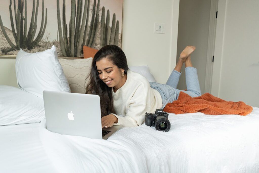 PhotoLoft Studio Brand Photos; photo of a woman laying on her stomach looking at a laptop