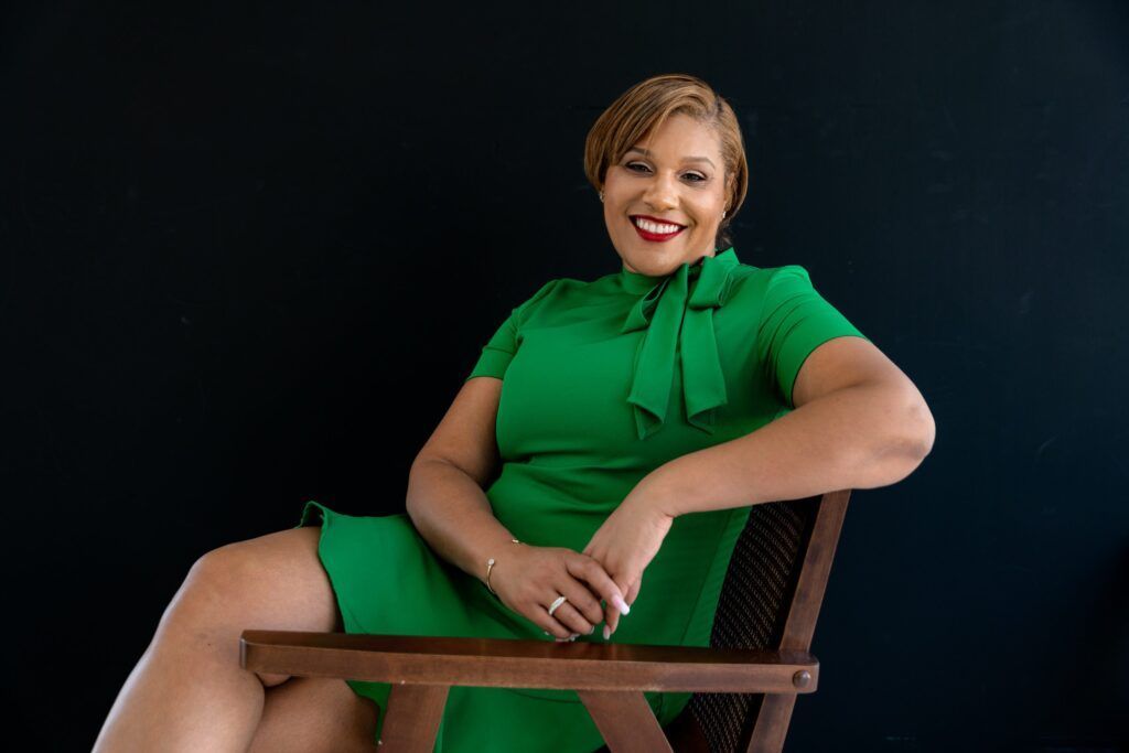 Lightbox Studio Dallas photoshoot locations; picture of a woman in a green dress sitting in a chair