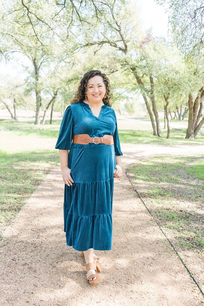 photo of a woman wearing a teal dress standing in a park. 

how much does a branding photographer cost