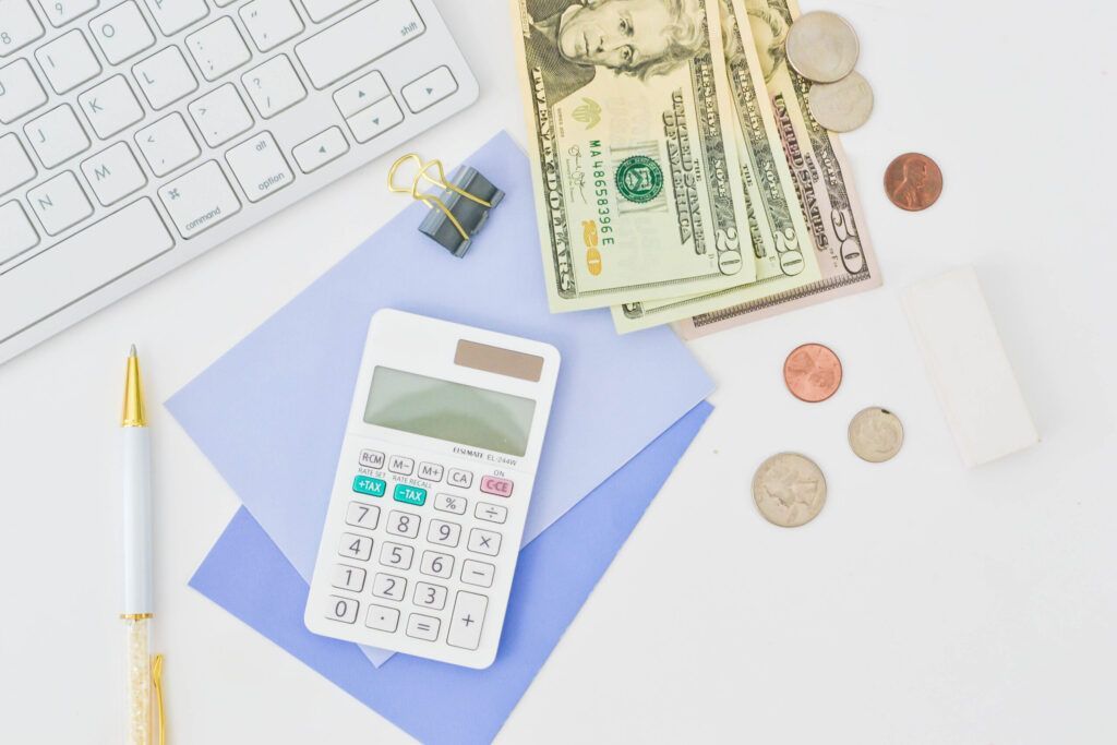 photo of a calculator and cash ; how to price your photography business