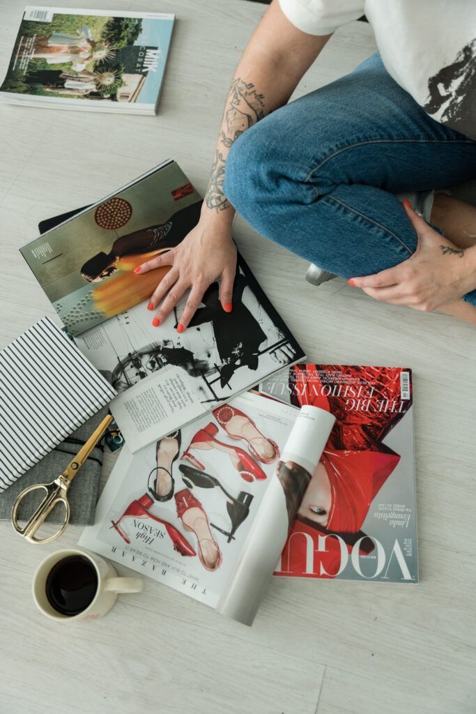 Photo of brand designer Natalia Gaitan looking at magazines on the floor by Dallas brand photographer Catie Ronquillo