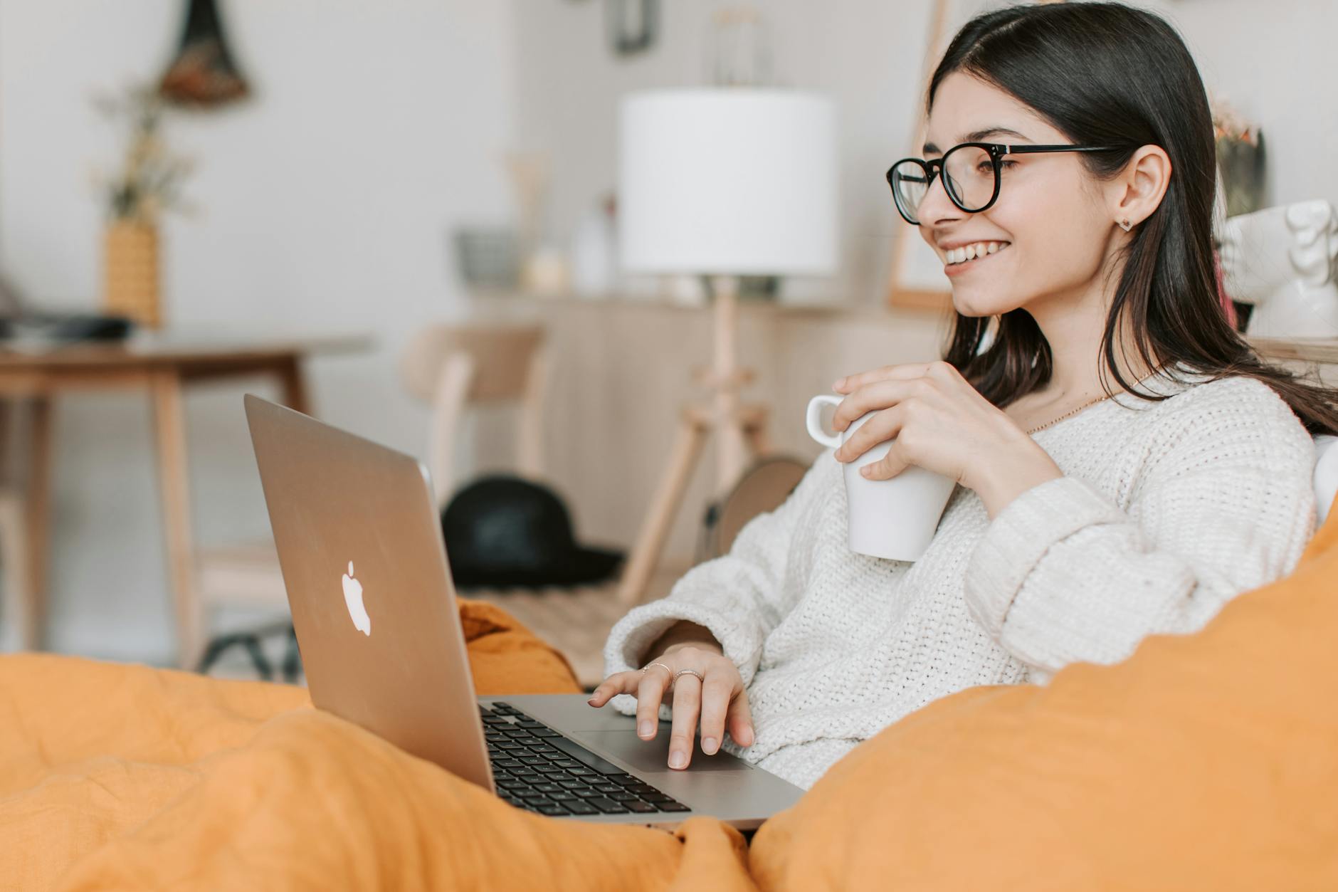 woman having coffee while using laptop ; starting an e-commerce venture