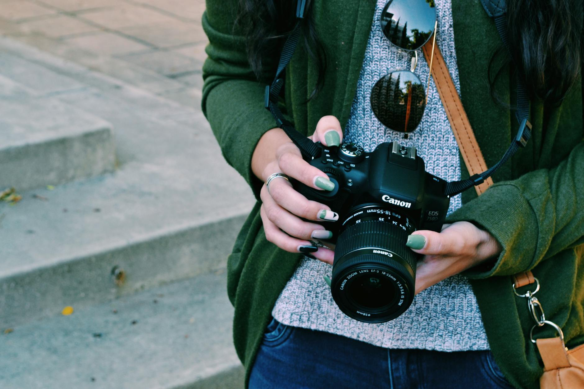 woman holding black canon dslr camera