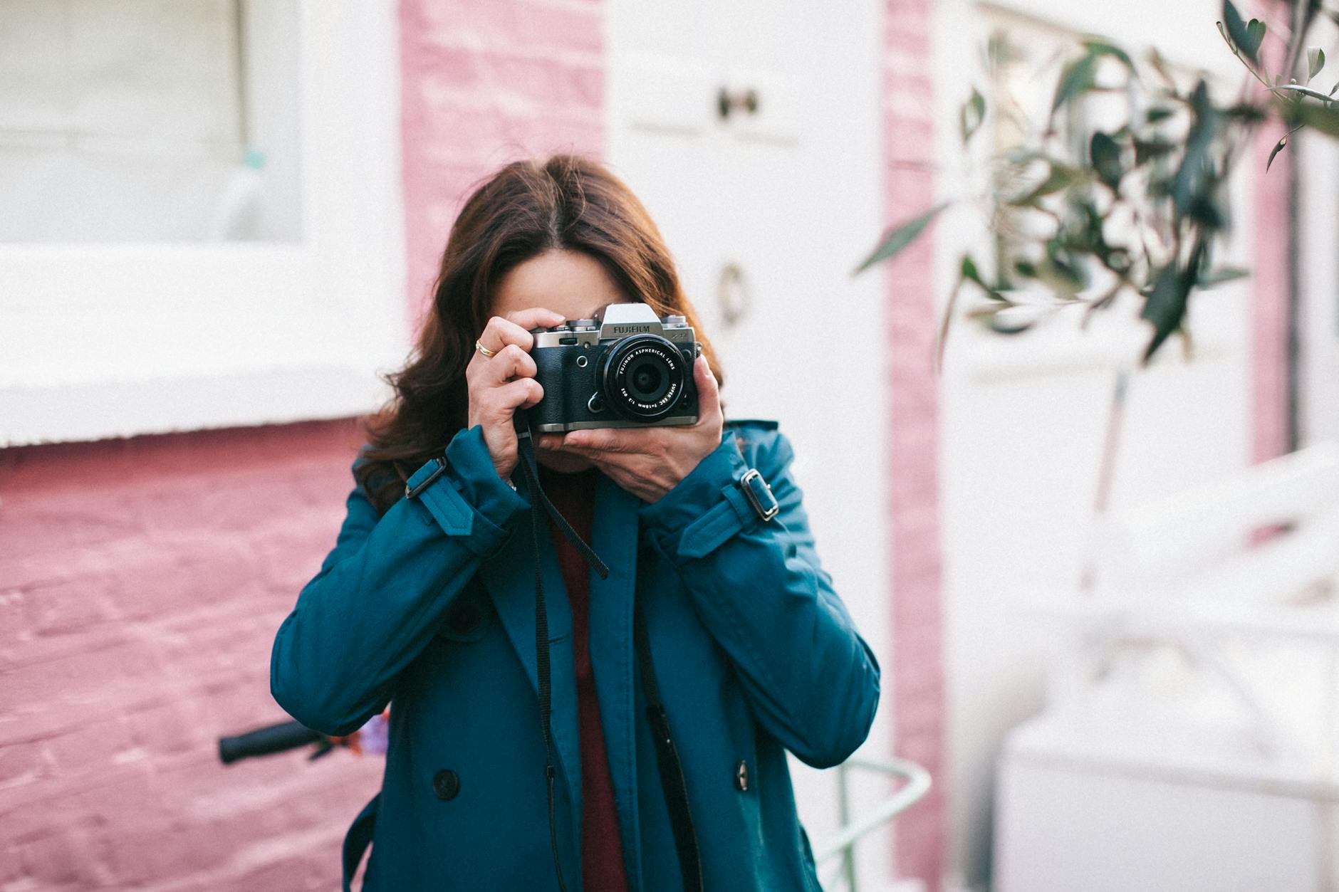 woman using black dslr camera