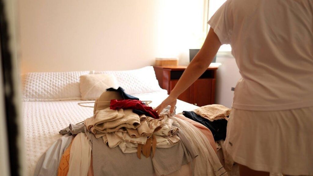 a woman decluttering her closet.