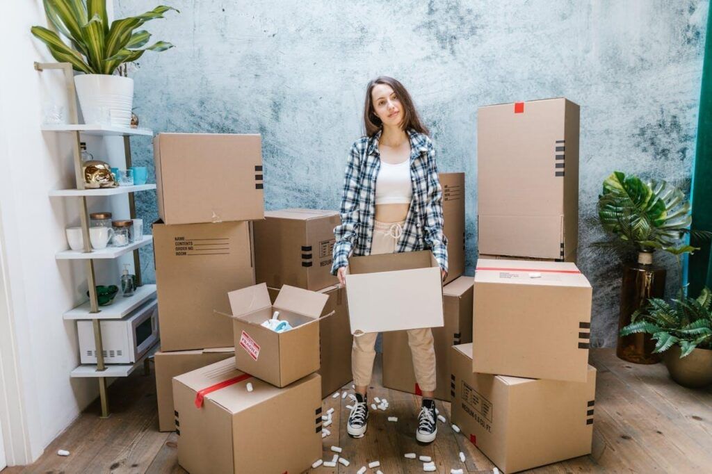 a woman moving into her new apartment, thinking about relocation as a catalyst for creative evolution